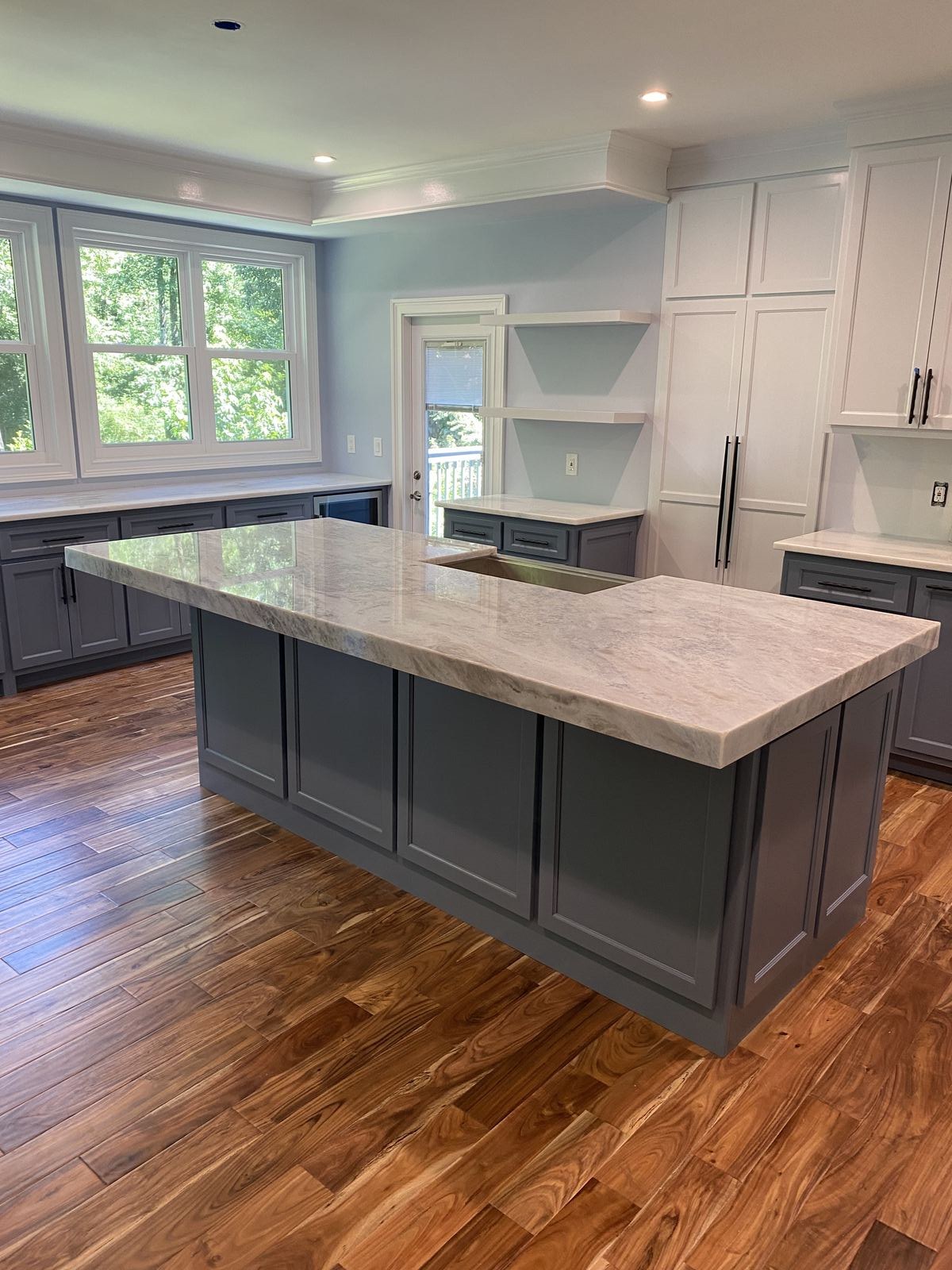 Australis Blue granite island with mitered waterfall edge installed in a Sugar Hill, GA kitchen