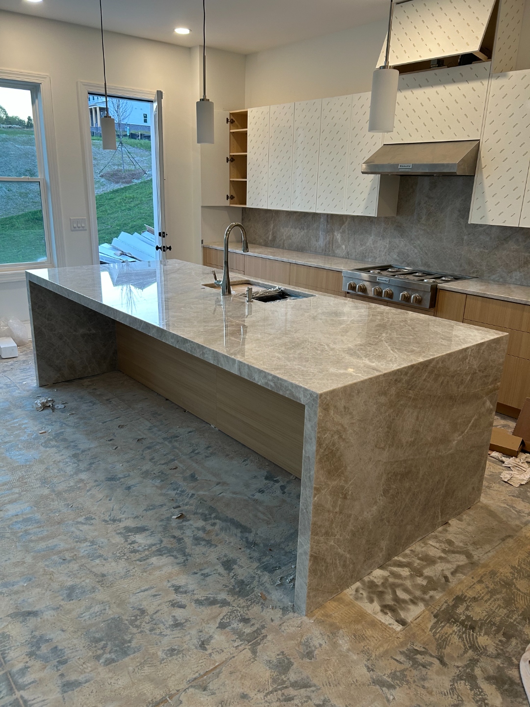 Finished Original Taj Mahal quartzite waterfall island installed in a Cumming, GA kitchen