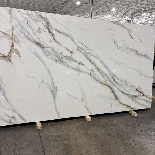 Printed Calacatta quartz slab close-up, white stone with bold grey and gold veining