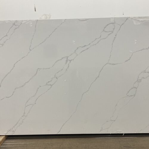 Calacatta quartz slab close-up, white stone with soft grey veining