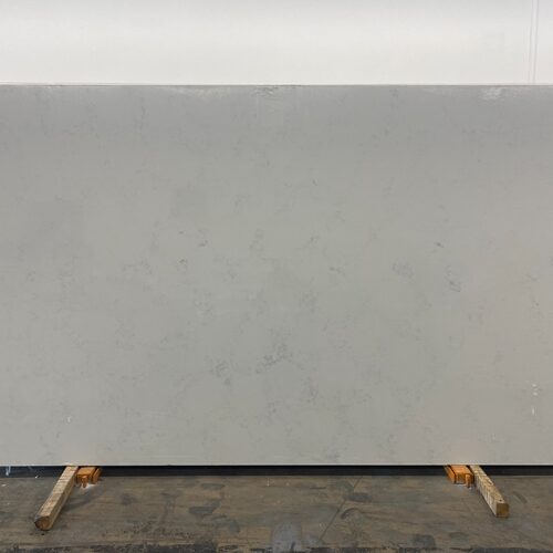 Carrara White quartz slab close-up, light grey stone with subtle mottling