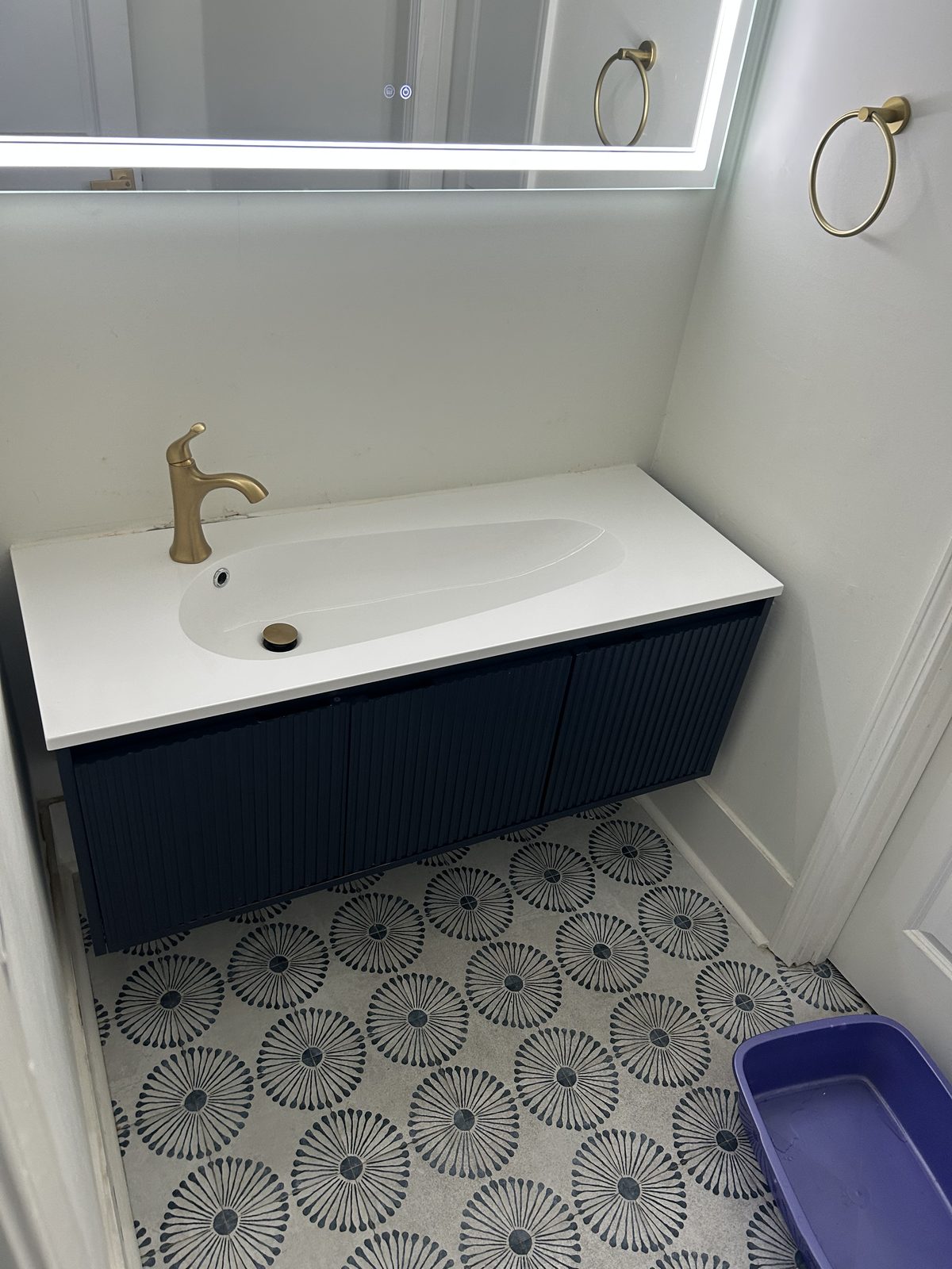 Before: the original wall-mounted bathroom vanity with a moulded integrated top